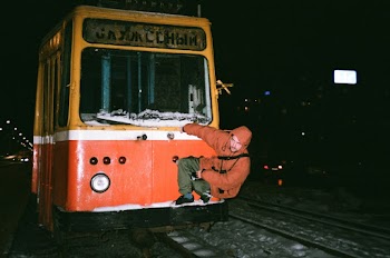 Man Holding On Train