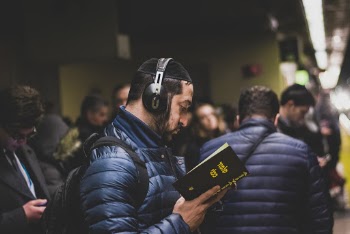 Man Holding Opened Book