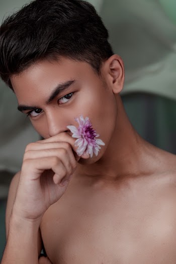 Man Holding Purple Flower on Her Hand