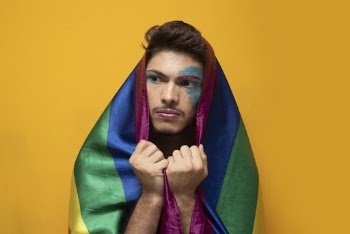 Man Holding Rainbow Color Flag