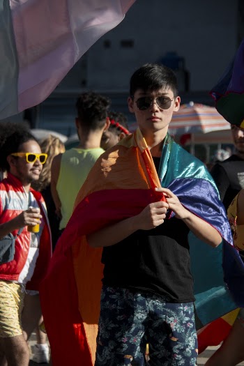 Man Holding Rainbow Coloured Flag