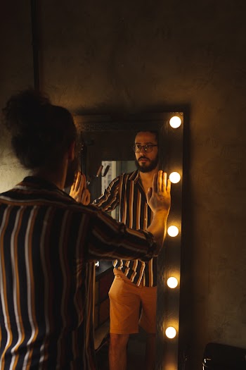 Man Holding Rectangular Mirror