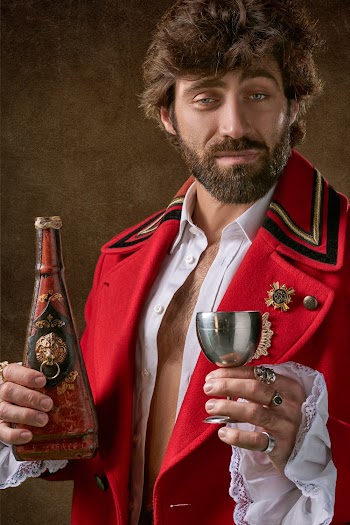 Man Holding Red And Black Bottle