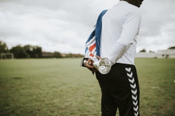 Man Holding Silver Trophy