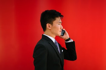Man Holding Smartphone Wearing Black Notched-lapel Suit Jacket