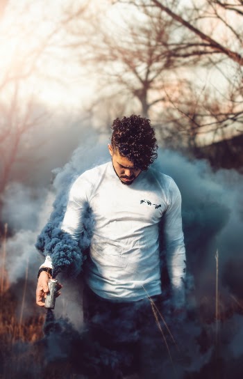 Man holding smoke outdoors