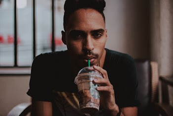 Man Holding Starbucks Cup