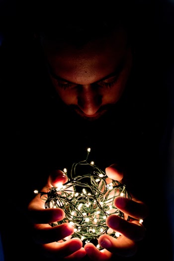 Man Holding String Light