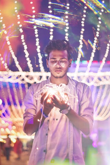 Man Holding String Light during Nighttime
