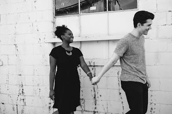 man holding the hand of woman beside him