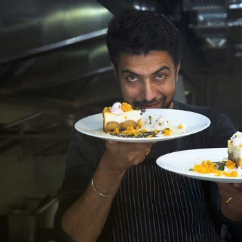 Man Holding Two Plates With Cooked Foods