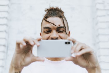 Man Holding White Phone