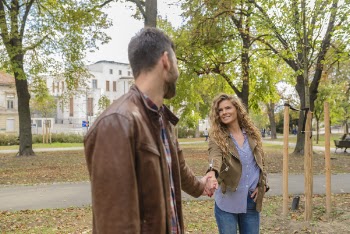 Man Holding Woman's Hand Near Trees