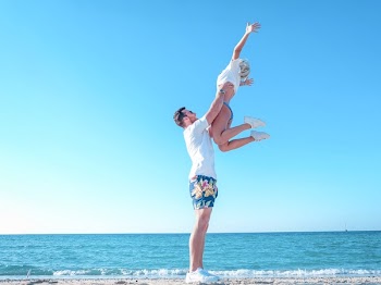 Man Holding Woman Near the Sea