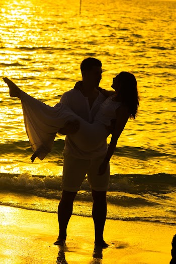 Man Holding Woman on Shore