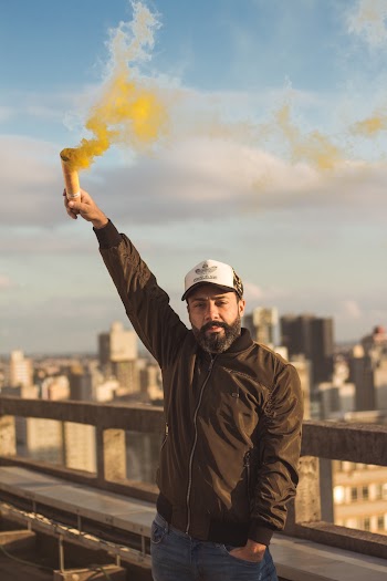 Man Holding Yellow Smoke Bomb