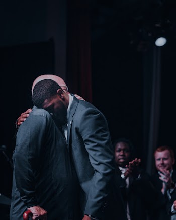 Man Hugging Another Man