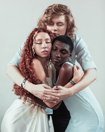 Man Hugging Two Women While Standing