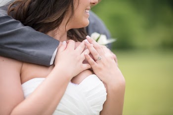Man Hugging Woman In White Strapless Bridal Gown
