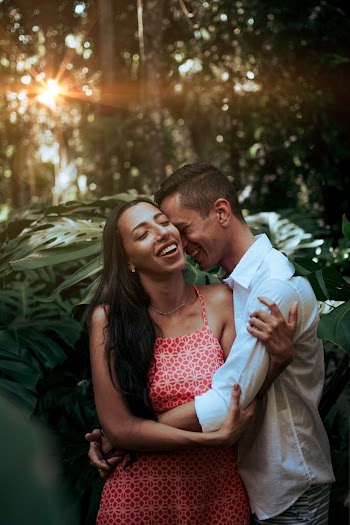 Man Hugging Woman Near Trees