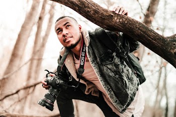 Man In A Jacket Holding Camera