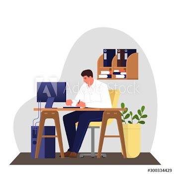 Man in a suit sitting at the desk and working on the computer