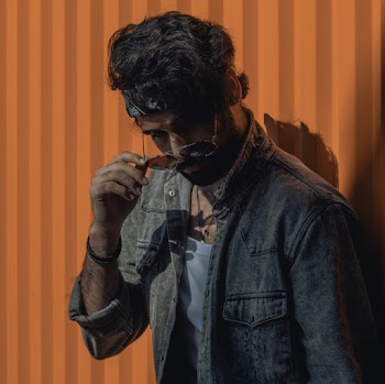 Man in Acid Wash Denim Jacket, White Shirt, and White and Black Bandana