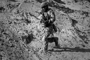 Man in Army Full Combat Uniform Carrying Rifle