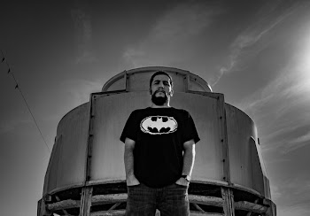 Man in Batman Print Shirt Stand Against Container