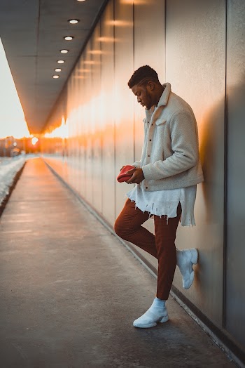 Man in Beige Jacket Leaning On Wall