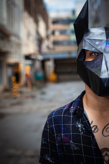 Man in Black and Gray Collared Top Wearing a Mask