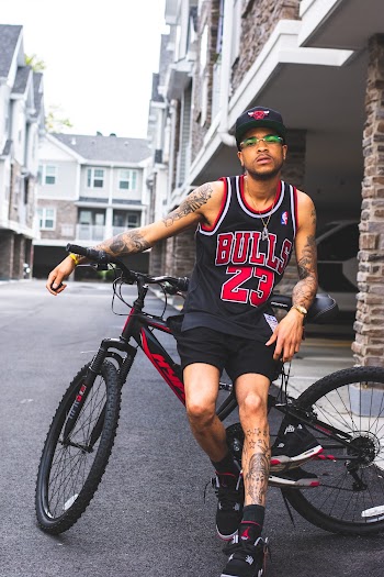 Man in Black and Red Chicago Bulls 23 Jersey Sitting on Bike