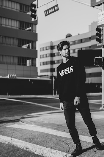 Man in Black and Whiten Long-sleeved Shirt in Grayscale Photography