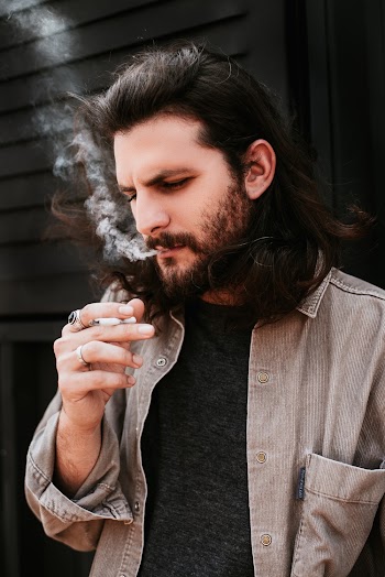 Man In Black Crew Neck Shirt Smoking