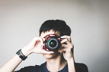 Man in Black Crew-neck Shirt Using Red Bridge Camera