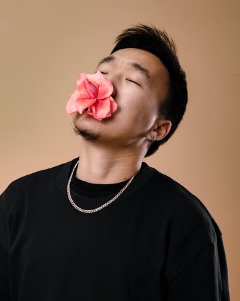 Man in Black Crew Neck Shirt With Pink Flower on His Mouth · Free Stock Photo