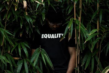 man in black crew-neck T-shirt in green leafed plant