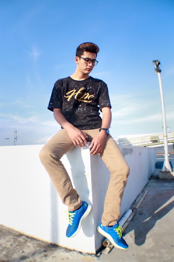 Man in Black Crew-neck T-shirt Sitting on the Concrete Block