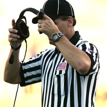 Man in Black Fitted Cap Holding Black Corded Headset
