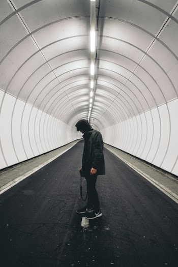 Man in Black Hoodie Standing Inside Panel