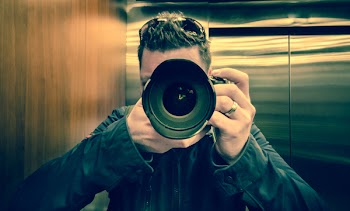 Man in Black Jacket Holding Black Dslr Camera