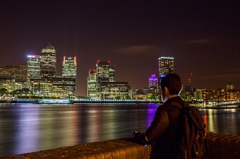 Man in Black Jacket Looking at the City