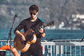 Man in Black Long-sleeved Shirt Playing Brown Acoustic Guitar
