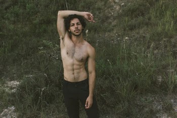 Man in Black Pants Standing Near Grasses