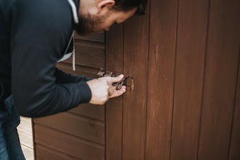 Man in Black Pullover Jacket Picking Lock