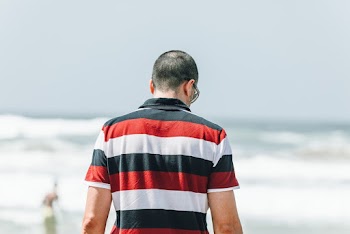 Man in Black, Red and Black Striped Polo Shirt