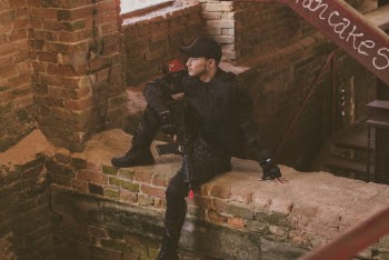 Man In Black Safety Gears Holding Airsoft Gun