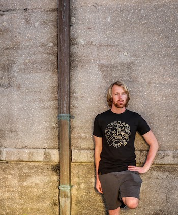 Man in Black Shirt and Bermuda Shorts