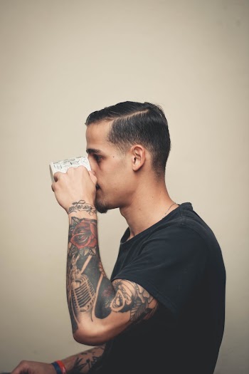 Man in Black Shirt Drinking from White Mug
