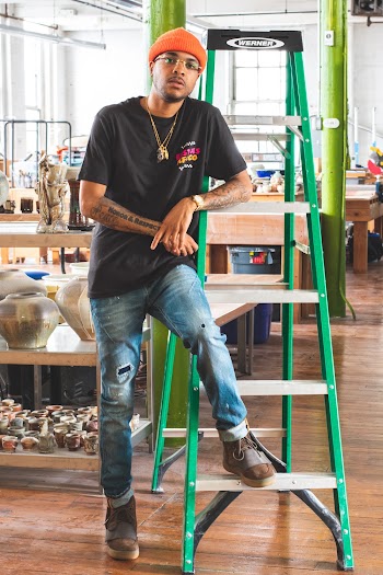 Man in Black Shirt Leaning by Ladder